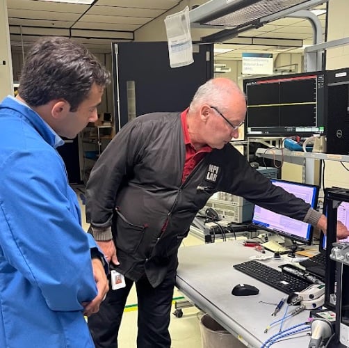 Jake Hertz (left) and Jeff Schuh (right) walking through test results on the Tektronix manufacturing floor.