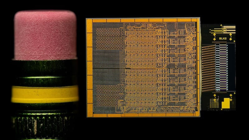 <em>Intel optical compute interconnect chiplets compared to size of apencil eraser.</em>